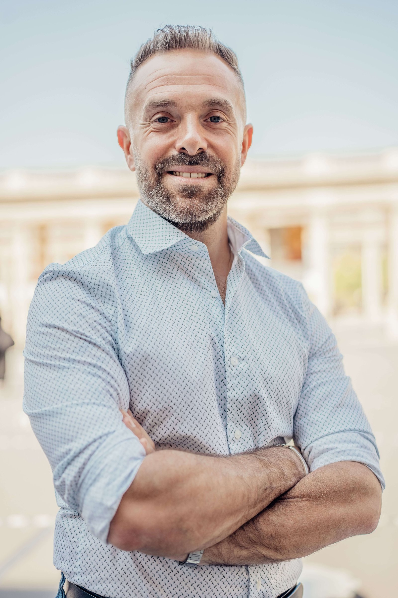 Man in his fifties standing outdoors looking healthy and relaxed